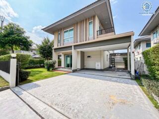 Modern two-story house with a spacious driveway and garage