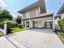 Modern two-story house with a spacious driveway and garage