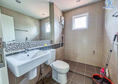 Modern bathroom interior with wall tiles and essential fixtures