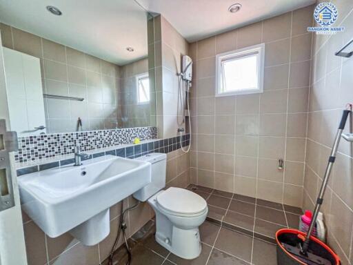 Modern bathroom interior with wall tiles and essential fixtures