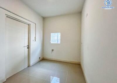 Empty bedroom with white walls and tiled flooring