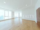 Spacious and Bright Empty Living Room with Hardwood Floors