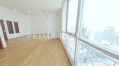 Spacious empty apartment interior with large windows and city view