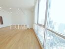 Spacious empty apartment interior with large windows and city view