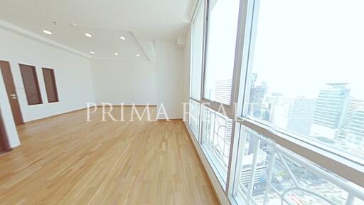 Spacious empty apartment interior with large windows and city view