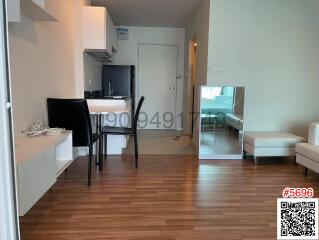 Modern apartment interior showing a compact kitchen and living space