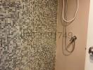 Modern bathroom with tiled shower and electric shower unit