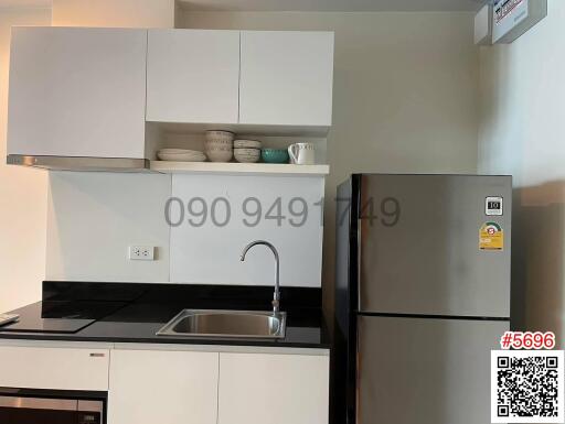 Modern kitchen with white cabinetry and stainless steel appliances