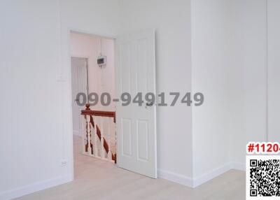 View of a white-walled corridor with doors leading to rooms inside a residential building