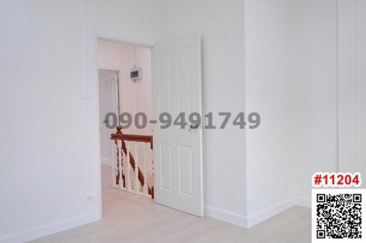 View of a white-walled corridor with doors leading to rooms inside a residential building