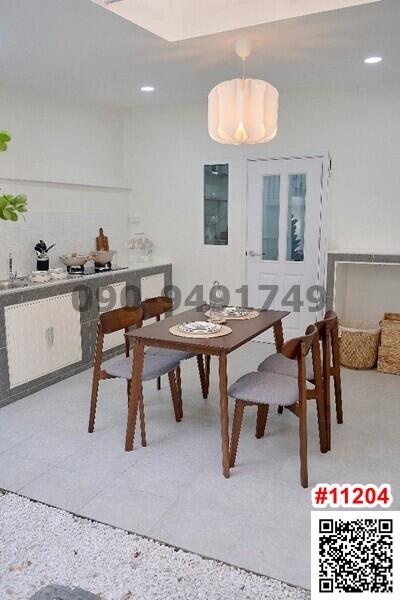 Modern dining area with table set and kitchen background