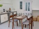 Modern dining area with table set and kitchen background