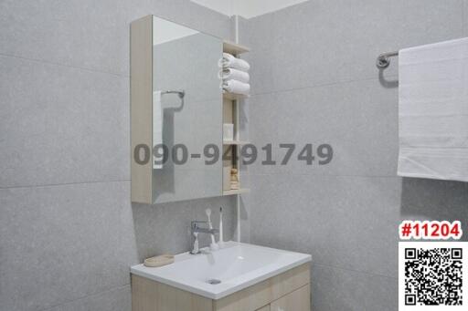 Modern bathroom interior with tile finishing and mounted sink cabinet