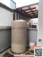 Outdoor utility area with water storage tank