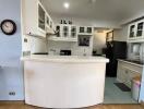 Spacious kitchen with modern appliances and white cabinetry