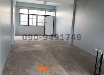 Spacious unfurnished interior of a new building with large windows and natural light