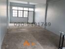 Spacious unfurnished interior of a new building with large windows and natural light
