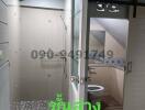 Modern bathroom with glass shower enclosure and stylish fixtures