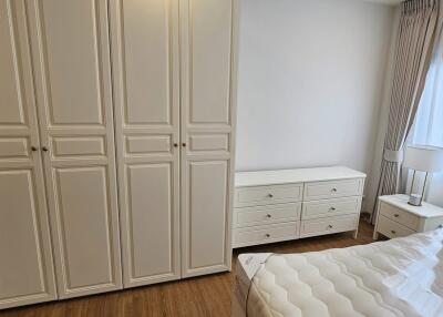 Spacious bedroom with large wardrobe and hardwood flooring