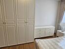 Spacious bedroom with large wardrobe and hardwood flooring