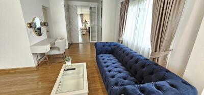 Elegant living room with a plush blue sofa and modern decor