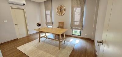 Minimalist bedroom with wooden desk and large windows