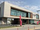 Modern commercial building exterior with large windows and a clear sky