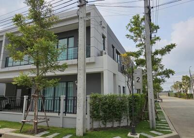 Modern two-story residential house with a well-maintained facade and a neat front yard