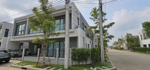 Modern two-story residential house with a well-maintained facade and a neat front yard