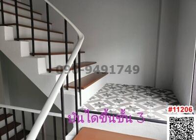 Interior staircase with patterned tiles and modern handrails