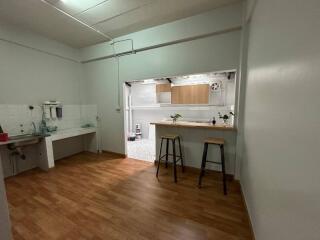 Compact kitchen with wooden flooring and modern amenities