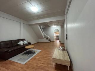 Spacious living room with staircase and modern furnishings