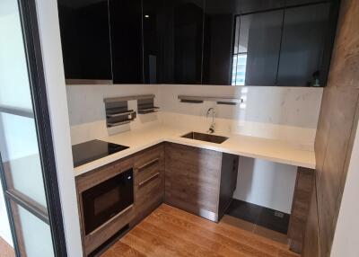 Modern kitchen with dark cabinetry and built-in appliances