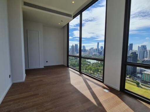 Spacious bedroom with large windows and city view