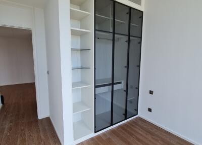 Spacious bedroom with built-in wardrobe and hardwood floors