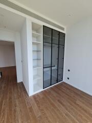 Spacious bedroom with built-in wardrobe and hardwood floors