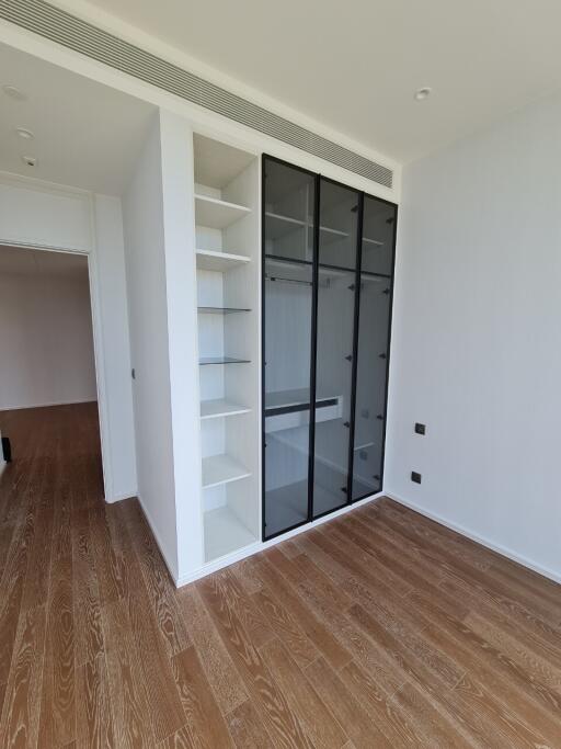 Spacious bedroom with built-in wardrobe and hardwood floors