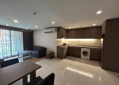 Modern open-plan living room and kitchen with washing machine
