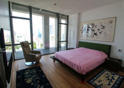 Modern bedroom with large windows and city view