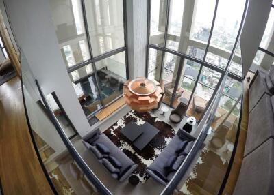 Modern living room with floor-to-ceiling windows overlooking the city