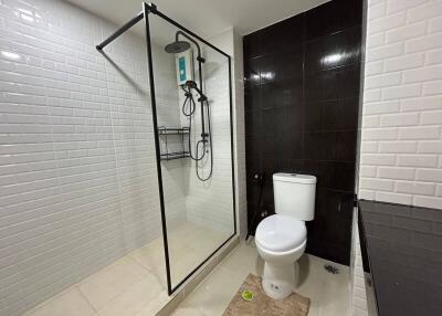 Modern bathroom with glass shower and white tiles