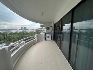 Spacious balcony with city view and laundry appliances