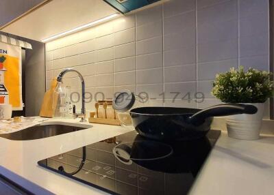Modern kitchen with induction stove and stylish backsplash