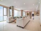 Spacious and well-lit living room with modern furniture and ocean view