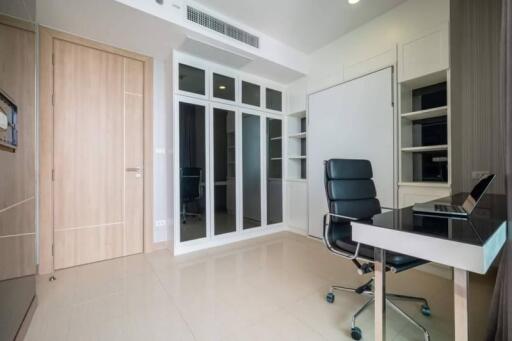 Modern home office with sleek furniture and ample storage space