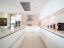 Modern kitchen with white cabinetry and stainless steel appliances