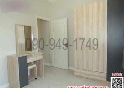 Spacious bedroom interior with large wardrobe and vanity