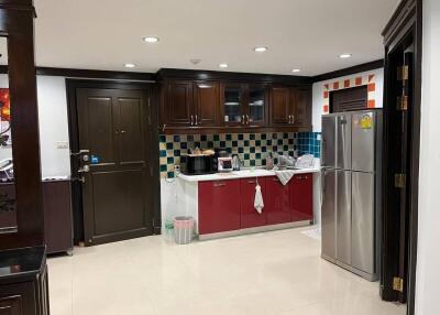 Modern kitchen with dark wood cabinets and stainless steel appliances