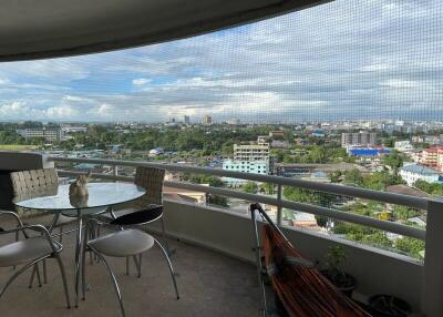 Spacious balcony with a scenic city skyline view and a comfortable seating arrangement