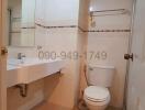 Modern white-themed bathroom with toilet and sink